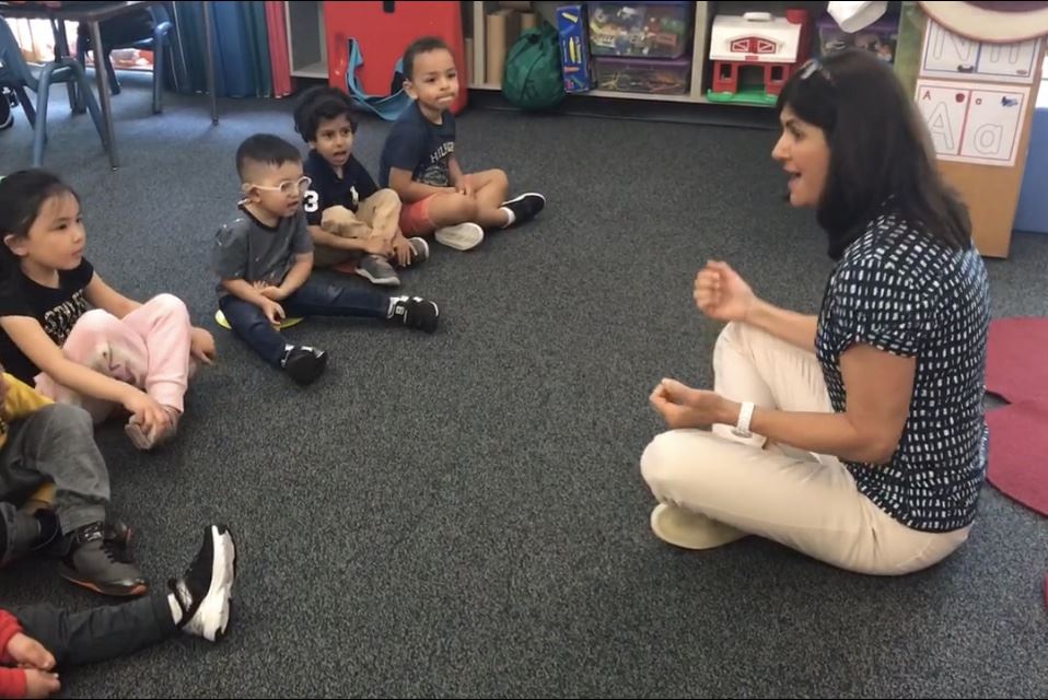 teacher doing yoga with kids