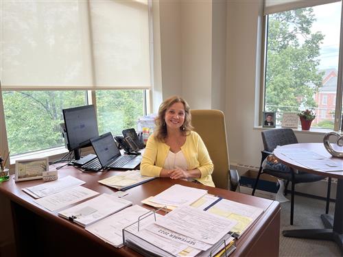 Grisel Espinosa smiling at her desk