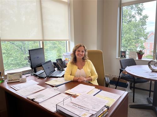 grisel espinosa smiling at her desk