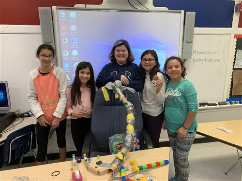 Students posing with Rube Goldberg machines 